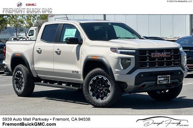 2026 GMC Canyon AT4 in Coastal Dune — front three-quarter view